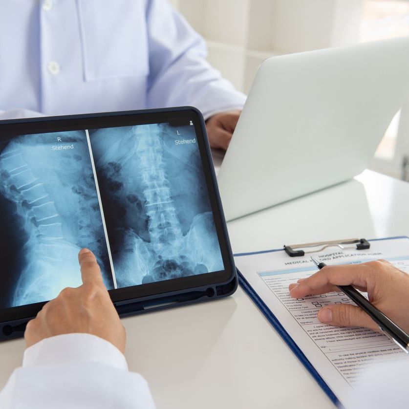 doctor diagnose spine lumber vertebrae x-ray image on digital tablet for diagnose.