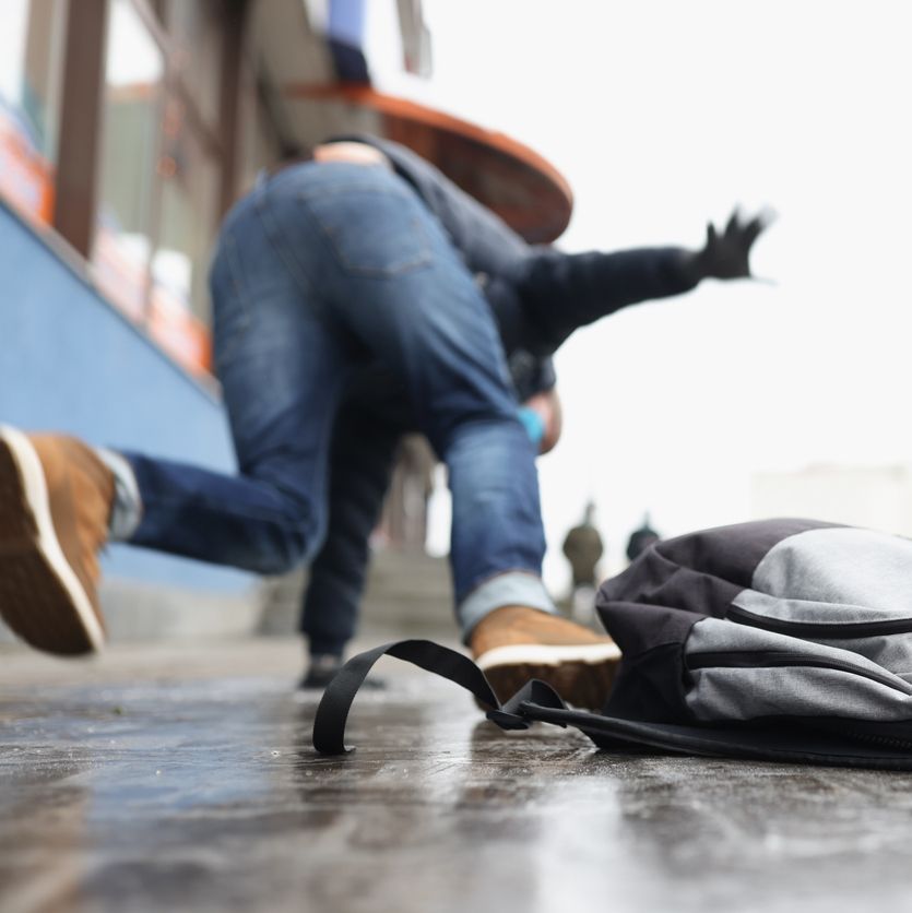 Close-up of person get injury after falling on slippery ground in winter season.